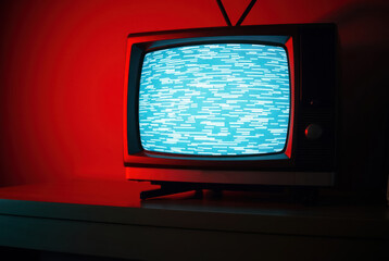 Television screen displaying static. White noise, distorted image.