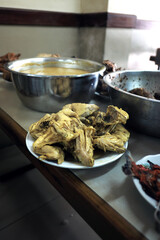 Ayam Gulai (chicken curry) in a Rumah Makan Padang setting, part of a traditional communal meal with other dishes.