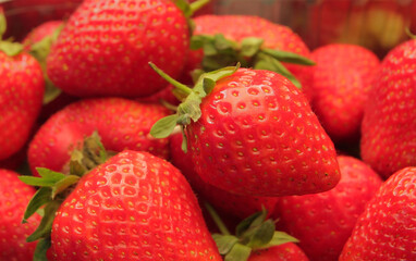 Beautiful, fresh, ripe strawberries on a wooden table. Concept, strawberries as a symbol of love and attractiveness. Strawberries are dietary, healthy, tasty, food rich in vitamins, antioxidants and m