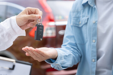 lease, rental car, sell, buy. Dealership manager send car keys to the new owner.  Sales, loan...