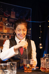  Professional female bartender preparing alcoholic drinks in a bar