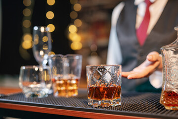 Professional female bartender preparing alcoholic drinks in a bar
