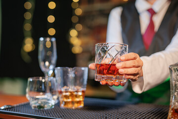  Professional female bartender preparing alcoholic drinks in a bar