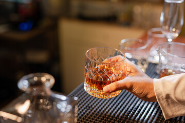 Professional female bartender preparing alcoholic drinks in a bar