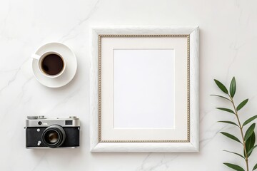 Flat lay of a vintage camera a cup of coffee and a blank picture frame on a marble surface with a green sprig