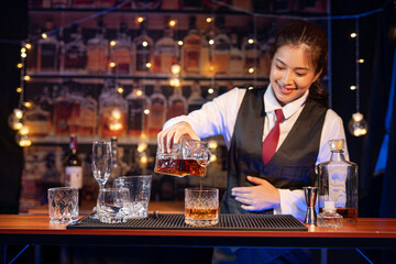  Professional female bartender preparing alcoholic drinks in a bar
