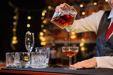  Professional female bartender preparing alcoholic drinks in a bar