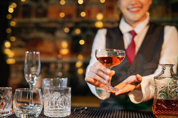  Professional female bartender preparing alcoholic drinks in a bar