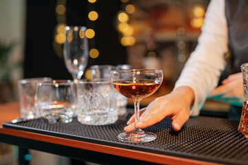  Professional female bartender preparing alcoholic drinks in a bar
