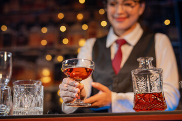  Professional female bartender preparing alcoholic drinks in a bar