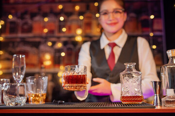  Professional female bartender preparing alcoholic drinks in a bar
