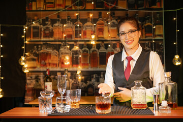  Professional female bartender preparing alcoholic drinks in a bar