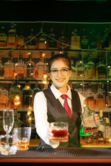  Professional female bartender preparing alcoholic drinks in a bar