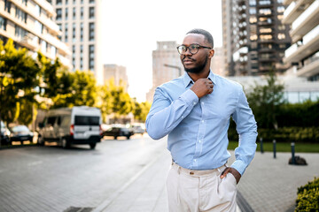 Confident businessman walking on a city street during the afternoon