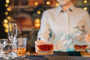  Professional female bartender preparing alcoholic drinks in a bar