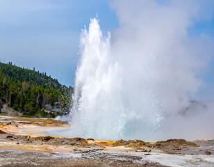 Majestic geyser erupts powerfully against a clear sky, showcasing natures raw force. Perfect for travel, science, or conservation projects. Inspiring image of power.