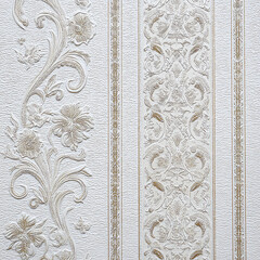 A wall with a floral design and a white stripe
