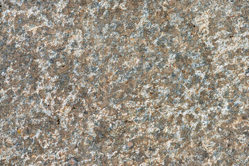 Detailed view of a textured stone surface featuring a blend of browns and grays, ideal for...