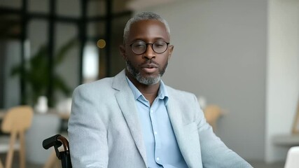 1_Businessman in wheelchair smiling during video call promoting inclusion - Powered by Adobe