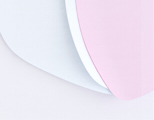 Close-up of layered pastel-colored paper sheets with gentle curves and shadows, creating a soft and minimalistic abstract composition