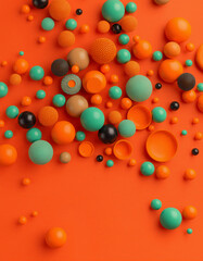 A vibrant assortment of colorful spheres scattered on an orange background, creating a lively and playful visual display with various sizes and shades including teal, orange, black, and beige.