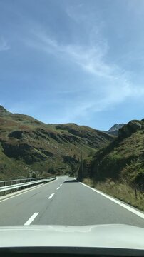 Fl&uuml;ela Pass mountain road on sunny afternoon. Empty mountain pass between the Albula Alps and Silvretta Alps in Switzerland.