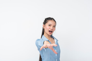 Young Southeast Asian woman in blue striped long sleeves reaches forward with an expressive hand...