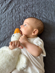 Baby Smiling with Plush Duck Toy