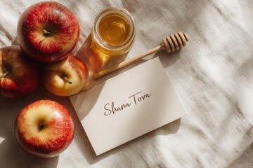 Rosh Hashanah card with the text 'Shan Tova', surrounded by red apples and a jar of honey with a wooden dipper.