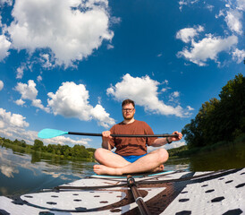 Man Taking Selfie on Paddleboard in Scenic Lake