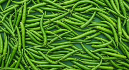 A Verdant Abundance: A Captivating Cluster of Fresh, Vibrant Green Chili Peppers A dense array of bright green chili peppers