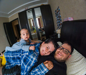 Happy Family Relaxing in Bedroom