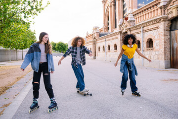 Three friends are having fun skating and skateboarding in a city park, enjoying the afternoon sun and urban landscape