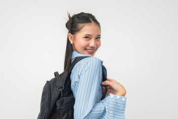 Close up of young Southeast Asian student wearing striped blue shirt and backpack, turning back...
