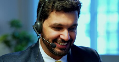 Indian businessman in call centre, Indian Asian corporate executive wearing headset and busy in communication, symbol of customer service, tech support, remote assistance, global connectivity - Powered by Adobe