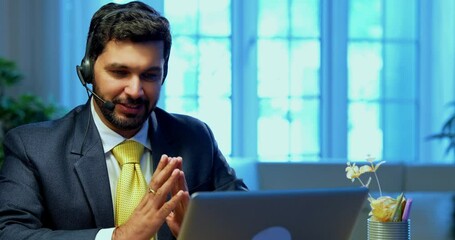 Indian businessman in call centre, Indian Asian corporate executive wearing headset and busy in communication, symbol of customer service, tech support, remote assistance, global connectivity - Powered by Adobe