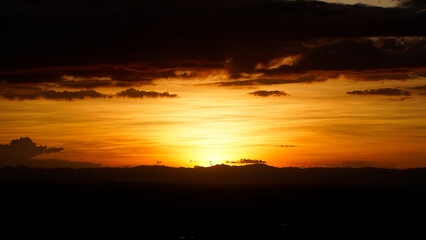 Fototapeta premium Golden sunset sky clouds in the evening sunrise.