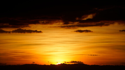 Golden sunset sky clouds in the evening sunrise.