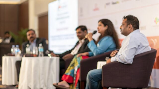 Indian professionals attending leadership panel discussion at corporate event
