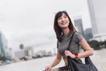 Solo Southeast Asian woman teenager blogger and world travel explorer wait to express joy on Chao...