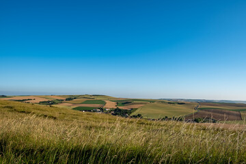 Cap Blanc-Nez, Escalles, Pas-de-Calais, Hauts-de-France, France, July 29th, 2025, A stunning panoramic view showcases lush green fields beautifully set against a vibrant bright blue sky