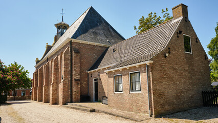 Rear view of historic Protestant church with annex in Driewegen, Zeeland