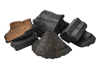 A pile of charcoal briquettes and coconut shell fragments on transparent background