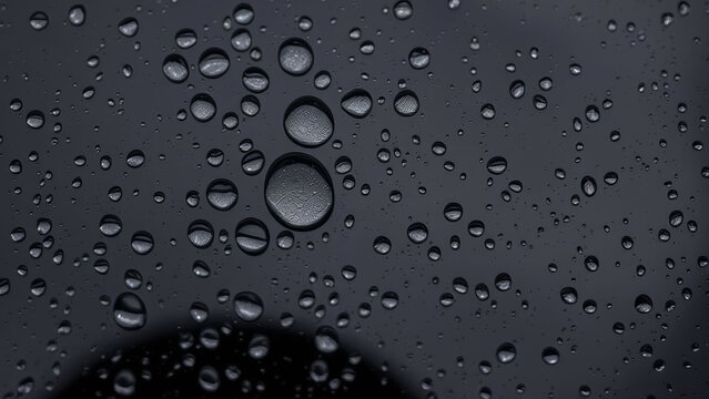 Close up of round water droplets reflecting light on a non stick surface, creating a textured pattern - Powered by Adobe