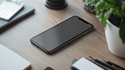 Minimalist Desk: Phone, Plant, and Notebook on Wood Grain Surface.