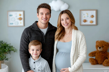 A happy family with a pregnant mother, father, and young son pose together in a cozy, softly decorated room with toys and plants.