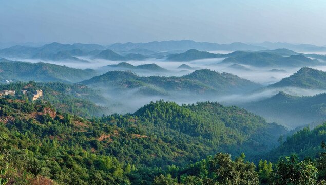 Misty mountain range panorama. Lush green hills covered in fog