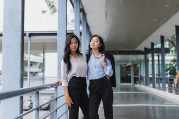 Two young businesswomen posing in modern office building