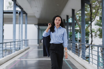 Fototapeta premium Young businesswoman walking in modern office building corridor