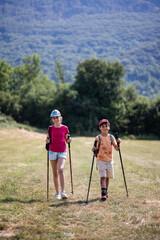 Two young hikers enjoying mountain trekking adventure
